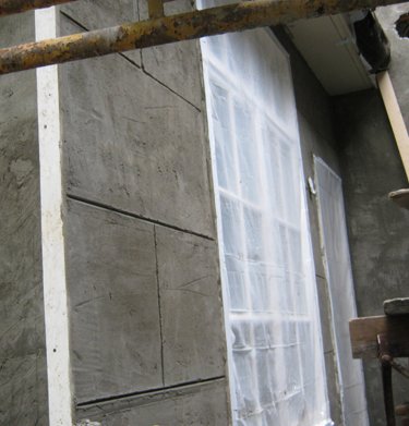 stucco  scored to look like block