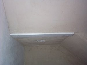 A wood strip is nailed to the brown coat